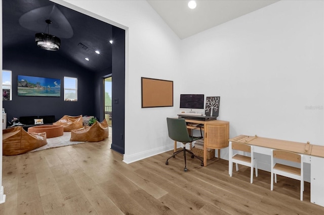 home office featuring wood-type flooring and high vaulted ceiling