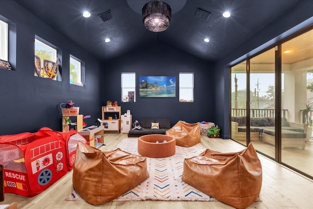 recreation room with vaulted ceiling and light wood-type flooring