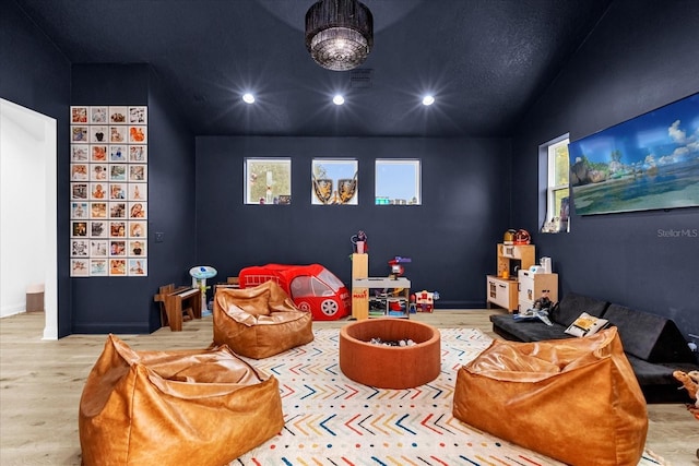 home theater room with wood-type flooring