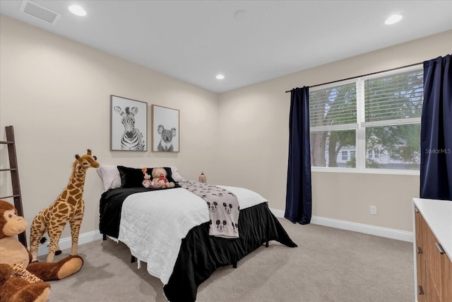 bedroom featuring light colored carpet