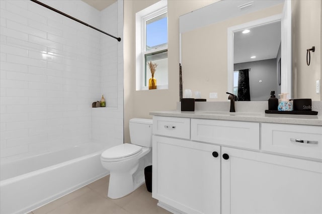 full bathroom featuring vanity, tiled shower / bath, tile patterned floors, and toilet