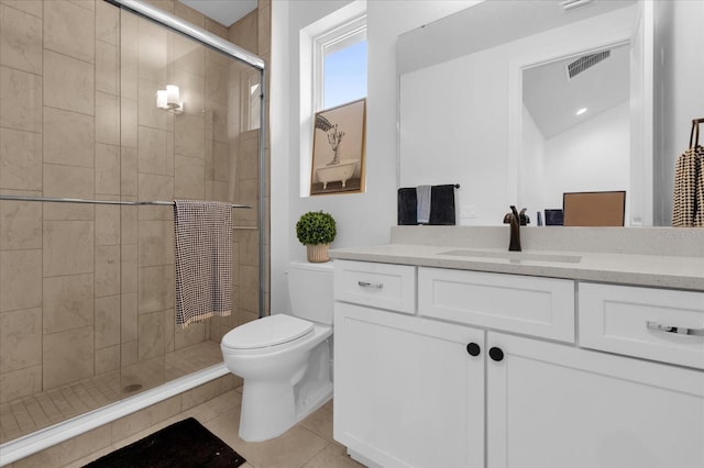 bathroom with tile patterned floors, vanity, toilet, and a shower with door