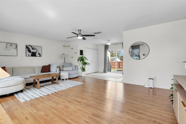 living area featuring ceiling fan and light wood-type flooring