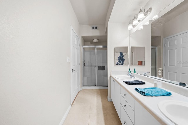 bathroom featuring vanity, tile patterned floors, and walk in shower