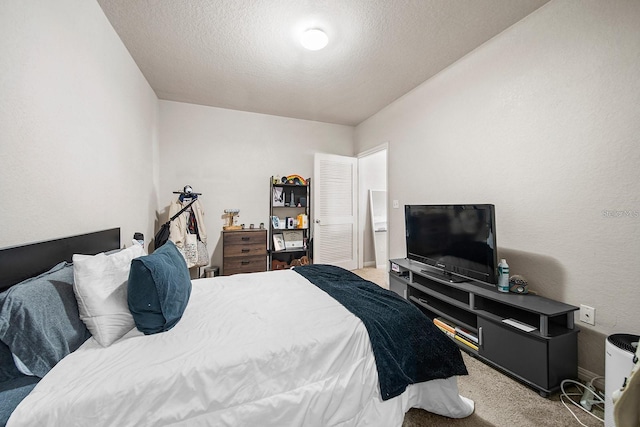 bedroom with light carpet and a textured ceiling