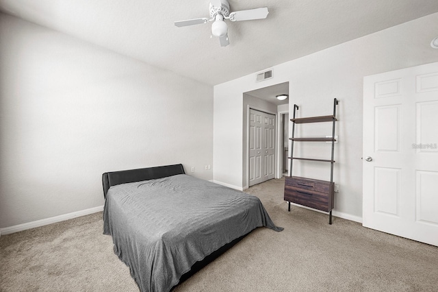 bedroom with ceiling fan, a closet, and light carpet