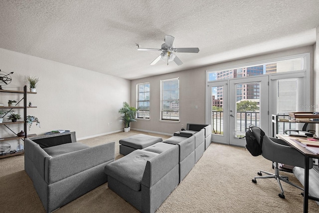 living room with french doors, light colored carpet, ceiling fan, and a textured ceiling