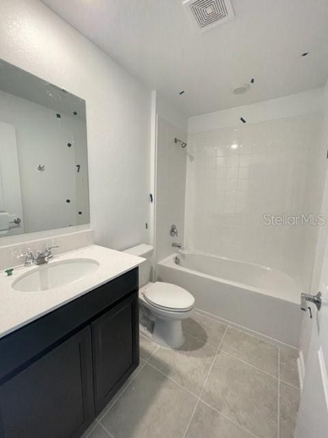 1148 Pomelo St, Davenport, FL 33837 - full bathroom featuring shower / bathing tub combination, vanity, tile patterned flooring, and toilet
