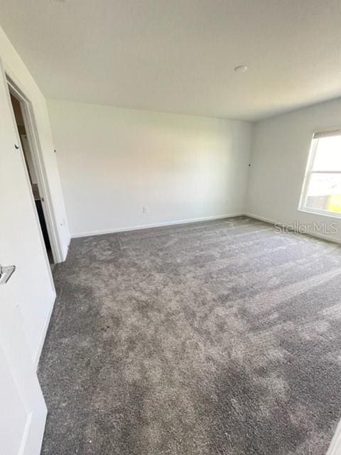 1148 Pomelo St, Davenport, FL 33837 - spare room with dark carpet