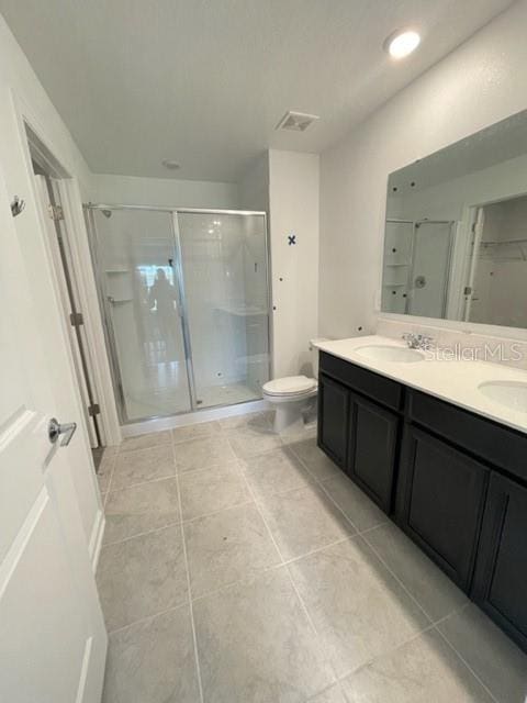 1148 Pomelo St, Davenport, FL 33837 - bathroom with vanity, an enclosed shower, tile patterned floors, and toilet