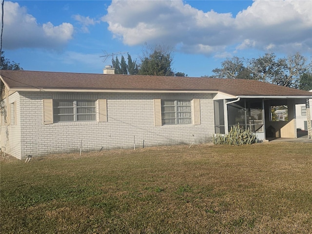 view of property exterior with a sunroom and a lawn