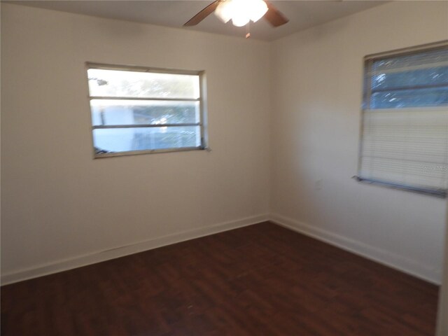 empty room featuring ceiling fan and dark hardwood / wood-style floors