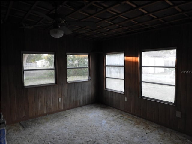 spare room featuring wooden walls