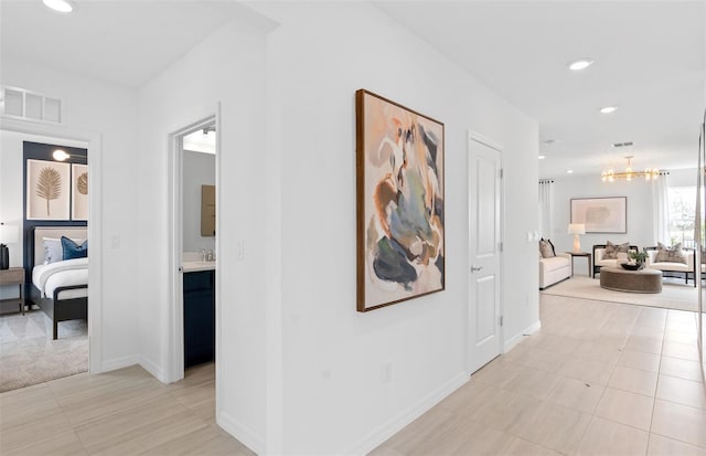 hallway with sink and light tile patterned floors