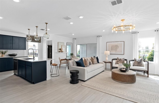 living room featuring sink and a notable chandelier