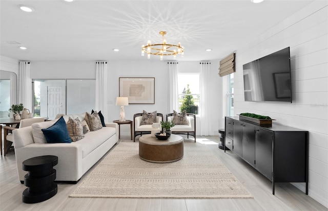 living room featuring light hardwood / wood-style floors and a notable chandelier