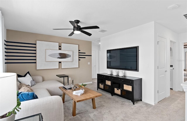 living room featuring ceiling fan and light colored carpet