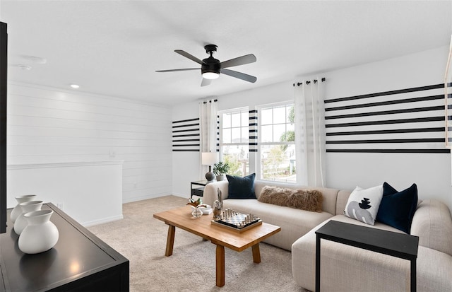 carpeted living room with ceiling fan