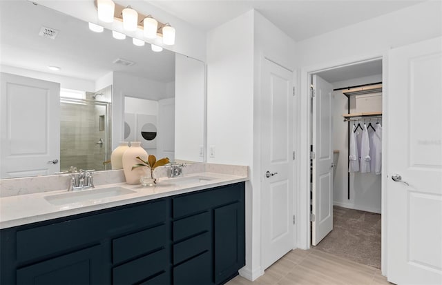 bathroom featuring walk in shower and vanity