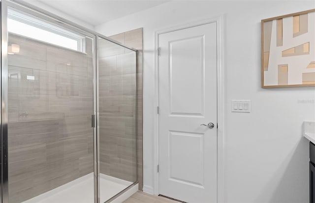 bathroom featuring vanity and a shower with shower door