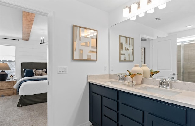 bathroom with beamed ceiling and vanity