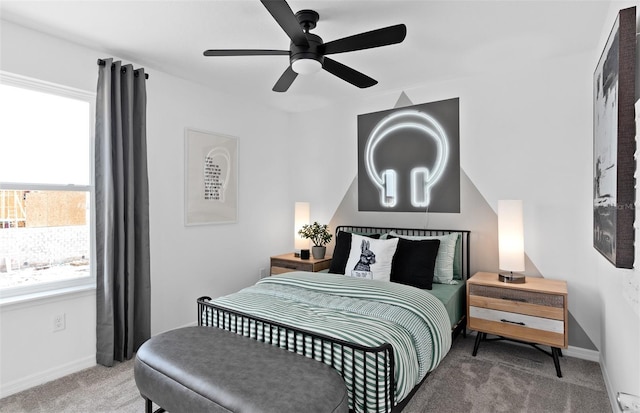 bedroom featuring multiple windows, carpet flooring, and ceiling fan