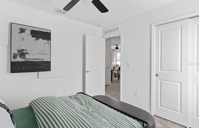 bedroom featuring light colored carpet and ceiling fan