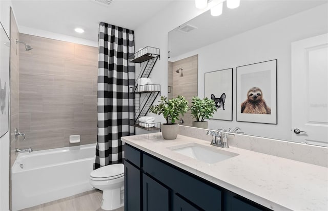 full bathroom featuring shower / tub combo, vanity, and toilet