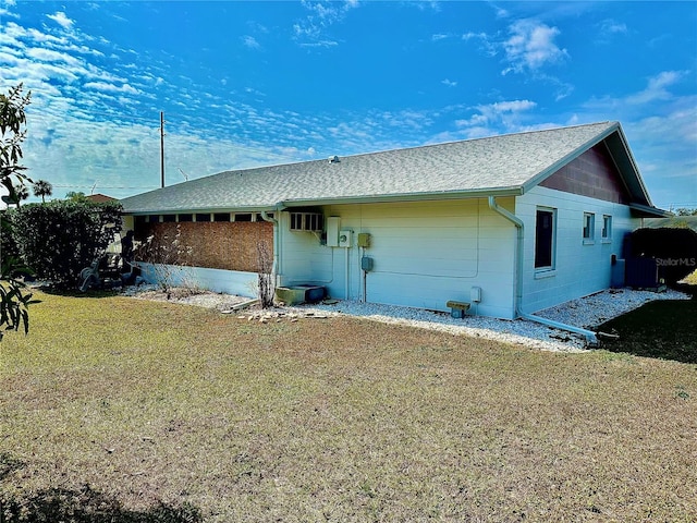 rear view of house featuring a lawn