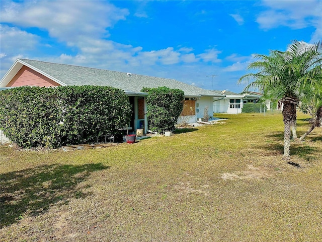 rear view of property with a yard