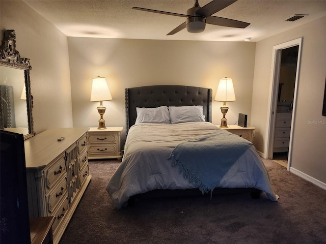 carpeted bedroom with ceiling fan, connected bathroom, and a textured ceiling