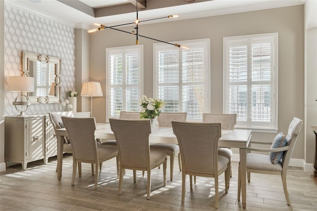 dining room with crown molding, plenty of natural light, and light hardwood / wood-style floors