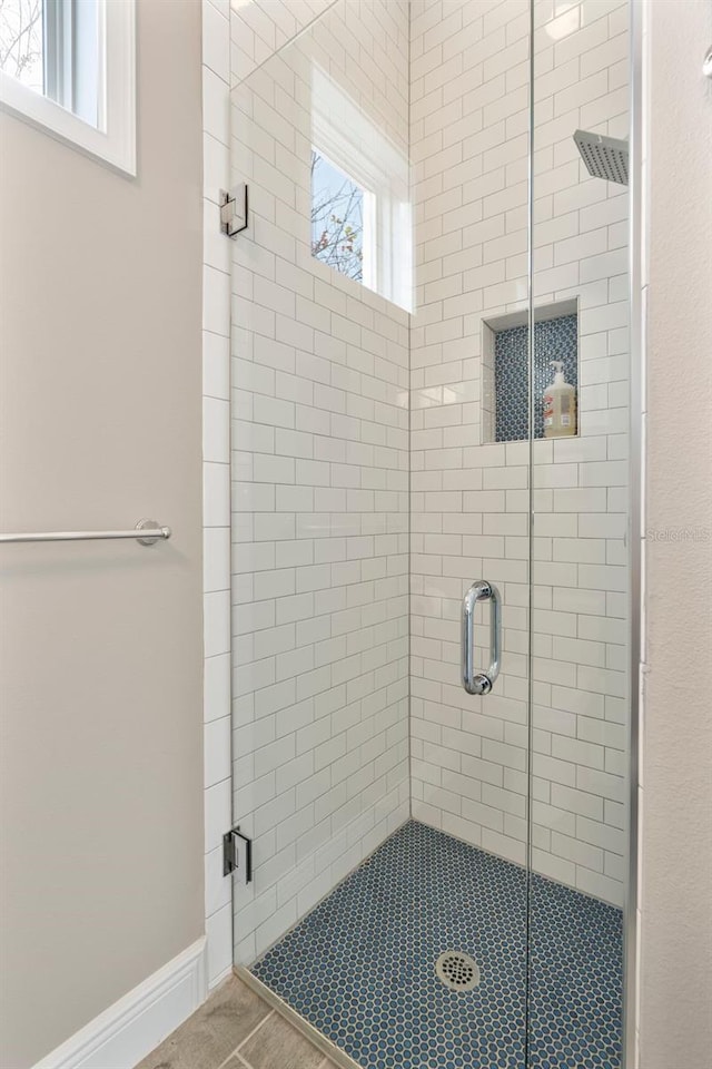 bathroom with a shower with shower door