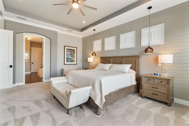 bedroom featuring crown molding, light colored carpet, a raised ceiling, and ceiling fan