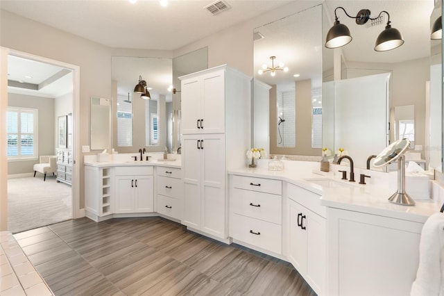 bathroom featuring vanity and a notable chandelier