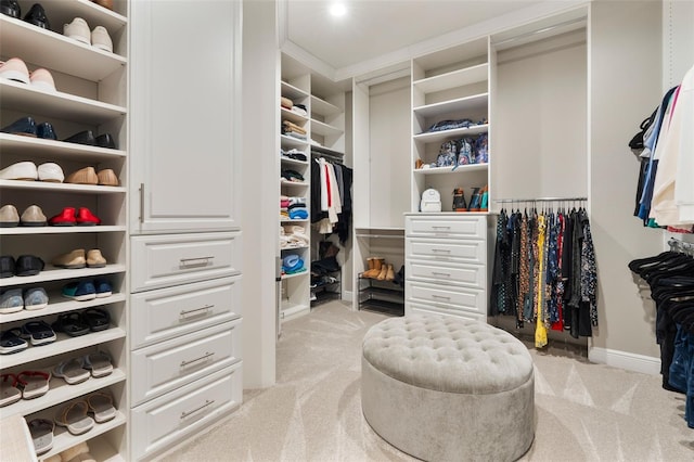 walk in closet with light colored carpet