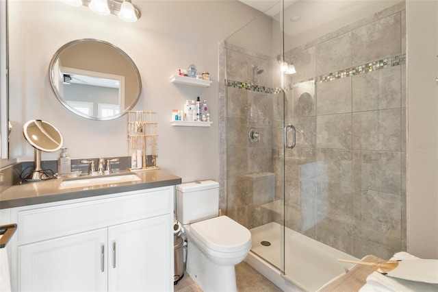 bathroom with vanity, toilet, and an enclosed shower