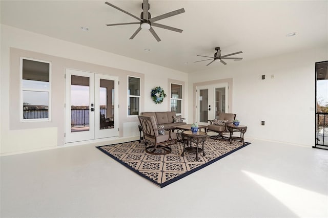 living room featuring french doors and ceiling fan