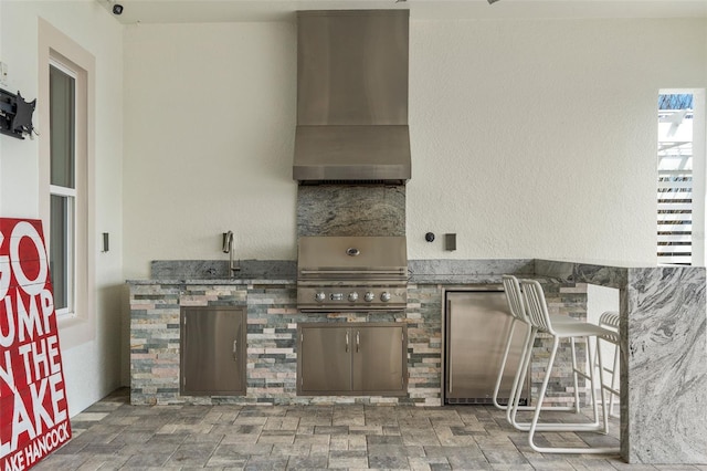 view of patio with an outdoor kitchen, sink, and area for grilling