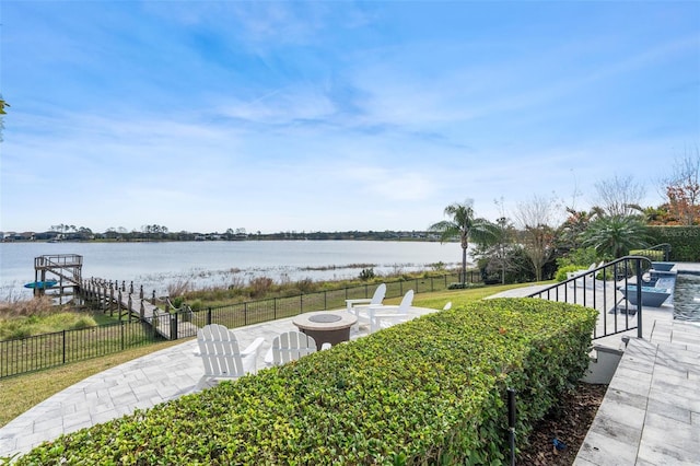 view of yard with a water view, a patio, and a fire pit