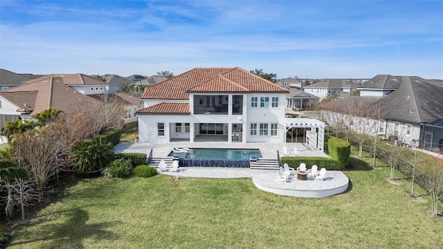 rear view of house with a yard, a pergola, and a patio area