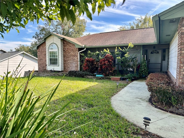 ranch-style house with a garage and a front yard