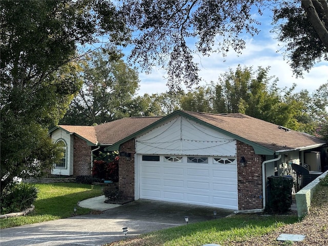 ranch-style home featuring a garage and a front lawn