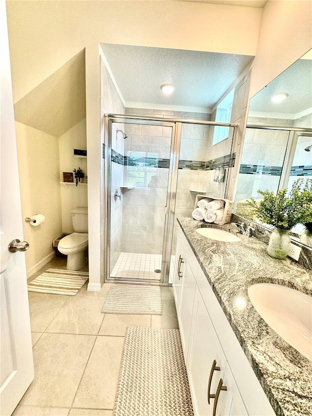 bathroom with lofted ceiling, vanity, a textured ceiling, toilet, and walk in shower