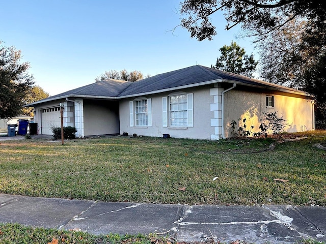 view of front of property with a garage and a front lawn