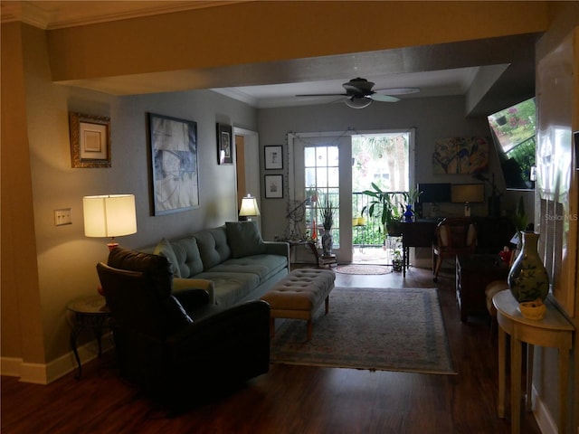 living room with crown molding, dark wood-type flooring, and ceiling fan