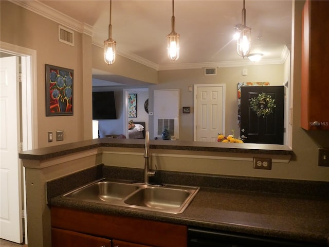 kitchen featuring sink, ornamental molding, and hanging light fixtures