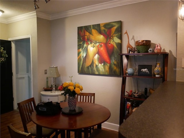 dining room featuring crown molding and wood-type flooring