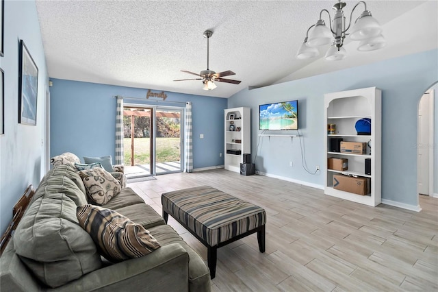 living room with ceiling fan with notable chandelier, vaulted ceiling, a textured ceiling, and light wood-type flooring