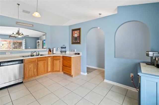 kitchen with lofted ceiling, sink, light tile patterned floors, decorative light fixtures, and stainless steel dishwasher